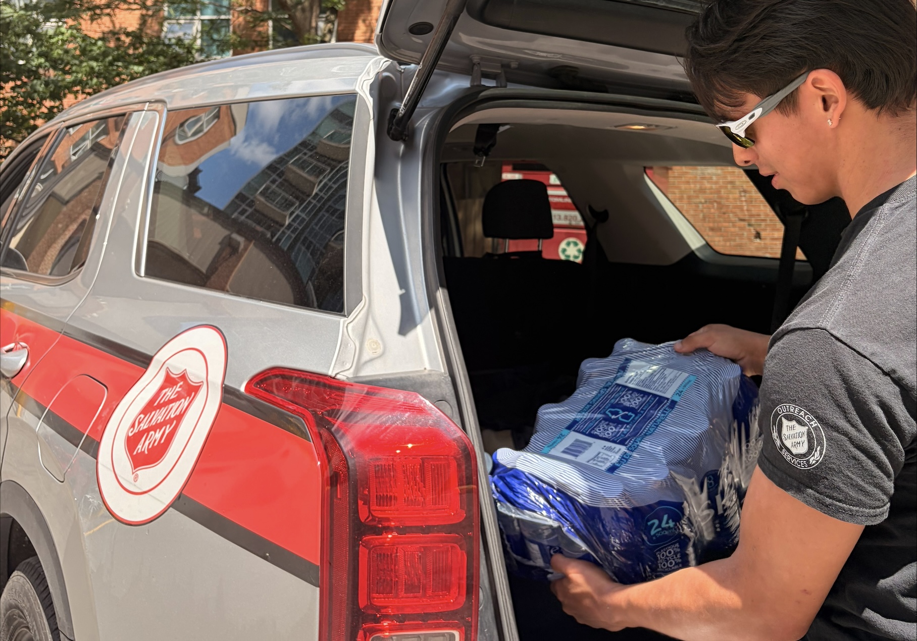 worker delivers water to the streets during extreme heat